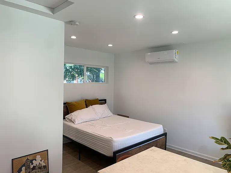 Bedroom with bed and mini split.