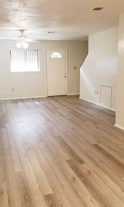 Your spacious and very light and bright living room glows with __ fresh paint __ new flooring __ new ceiling fan.