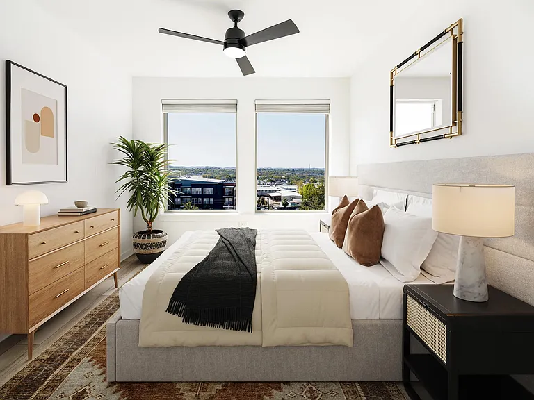 A light-filled bedroom at Modera Nations in Nashville offers calming views, clean lines, and a flexible layout designed for restful, everyday living.