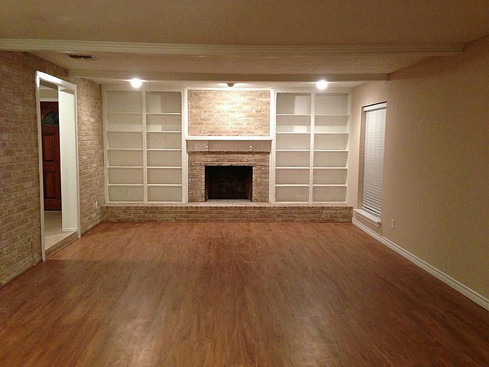 View of the oversized family room with fireplace, and dome lighting.