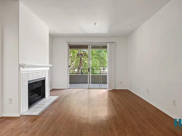 Living Room with Electric Fireplace, Vinyl Flooring, and Patio