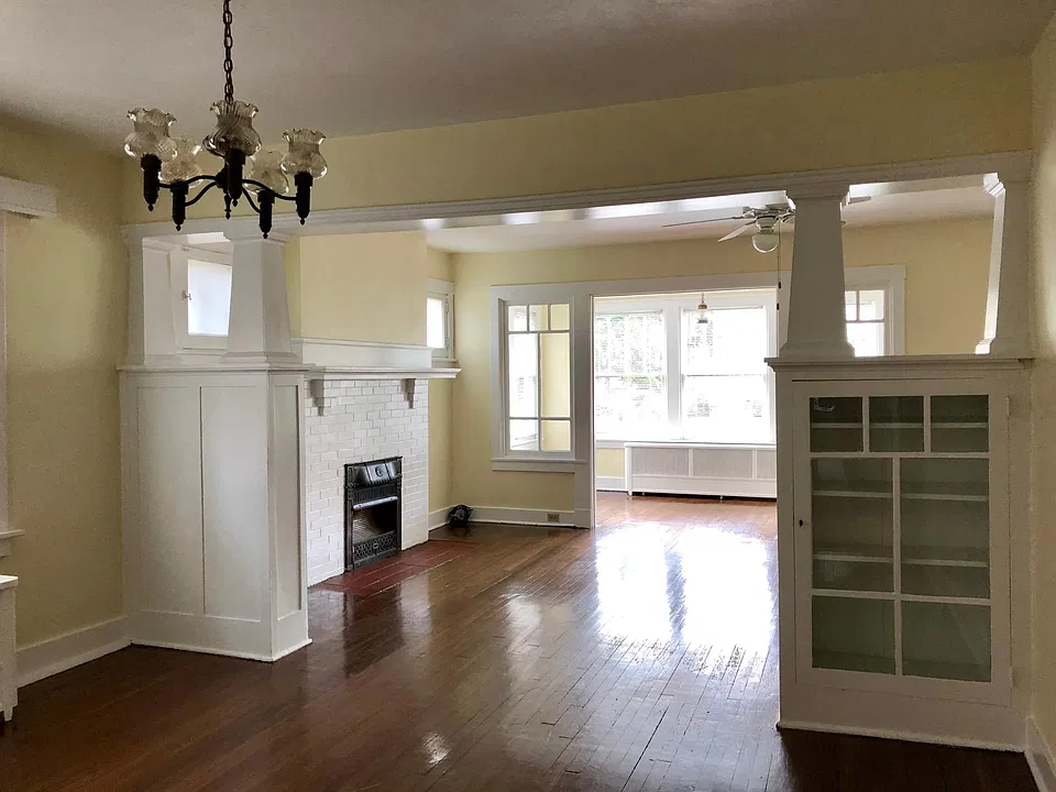 DR + LR + Sun Room with fireplace and built-in shelving units