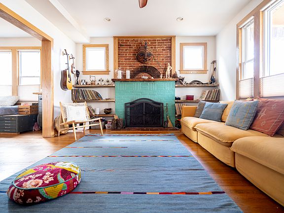Living room with large comfortable couch and working fire place.