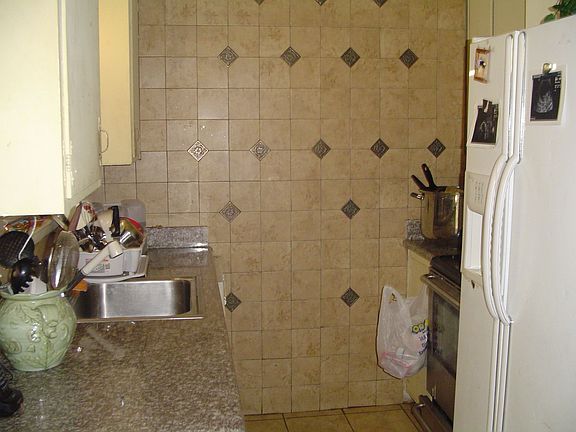 granite tops and tile floor and walls in kitchen