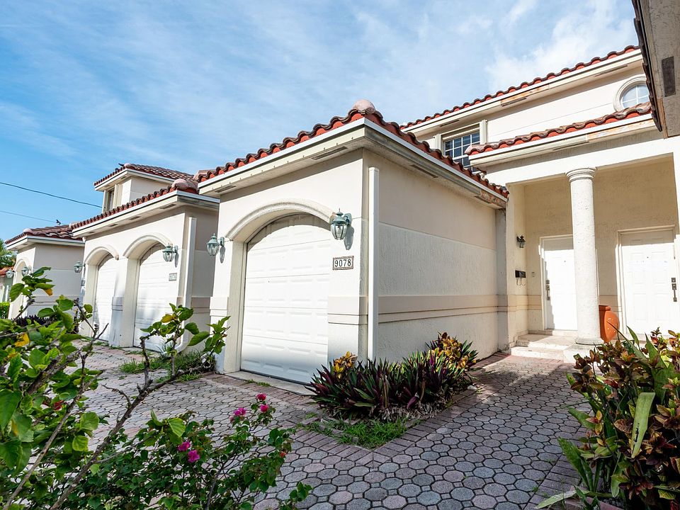 Front view - private entry, driveway, and parking garage