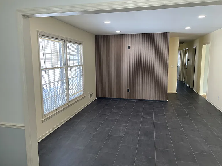 This photo shows the beautiful luxury vinyl flooring and walnut panel wall to hang your flat screen TV.
