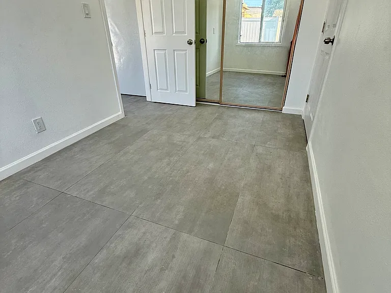 Bedroom complete with hardwood floors and a closet.