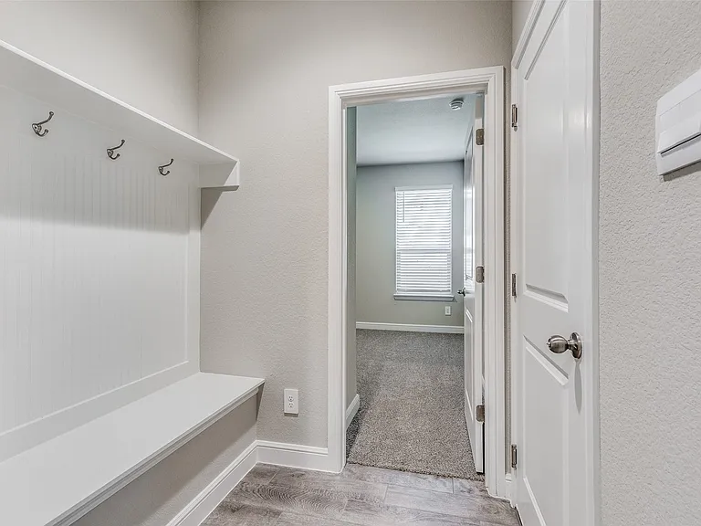 Mudroom with light hardwood / wood-style flooring