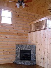 The living room features a stone gas fireplace.