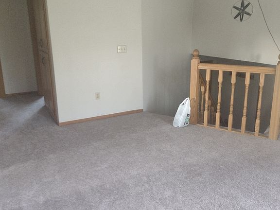 At the top of the stairs, there's a large living room area. It's a perfect spot for a large couch and tv setup.