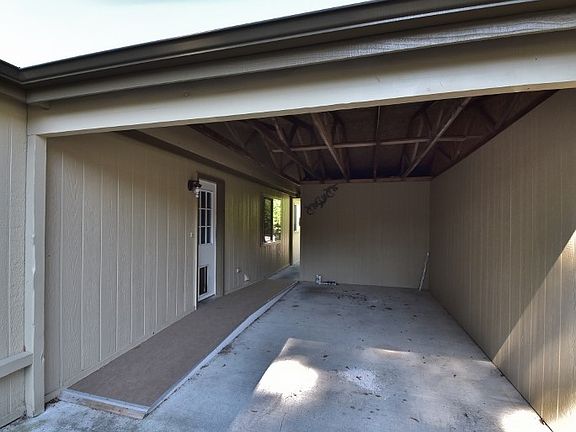 3 sided carport with storage on the end.
