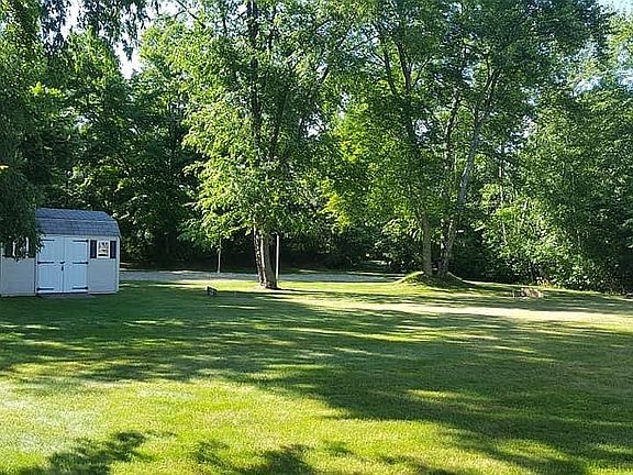 wooded acre with shed
