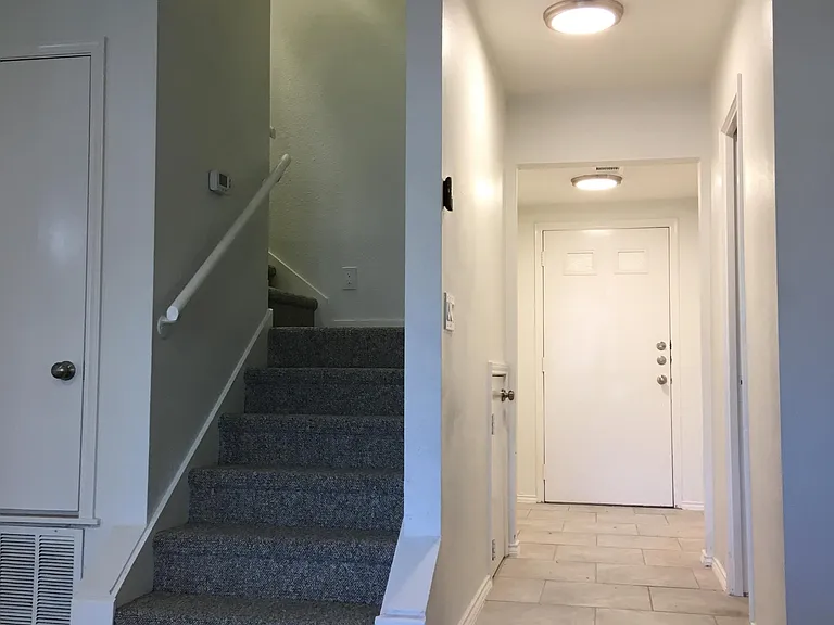 Bright entry with large coat closet, storage under stairs and a half bath for guests