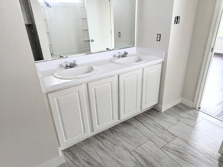 Master Bathroom
New tile, toilet and fixtures, with double vanity sink in master bathroom.