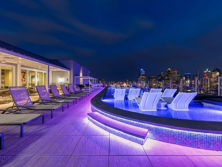One UptowStunning rooftop pool with city views and lounge seating
