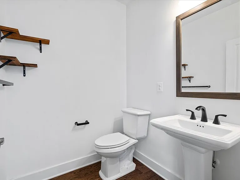 Powder room on the entry floor next to the stairwell