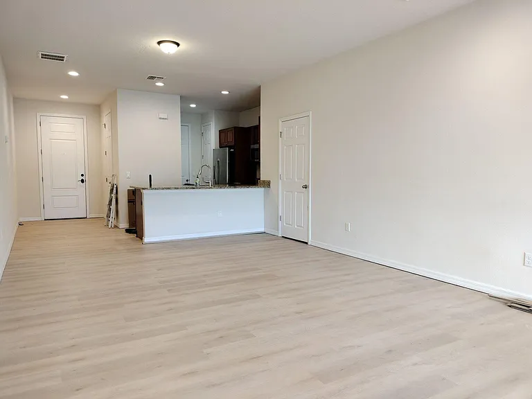 Living room with storage closet and half bath