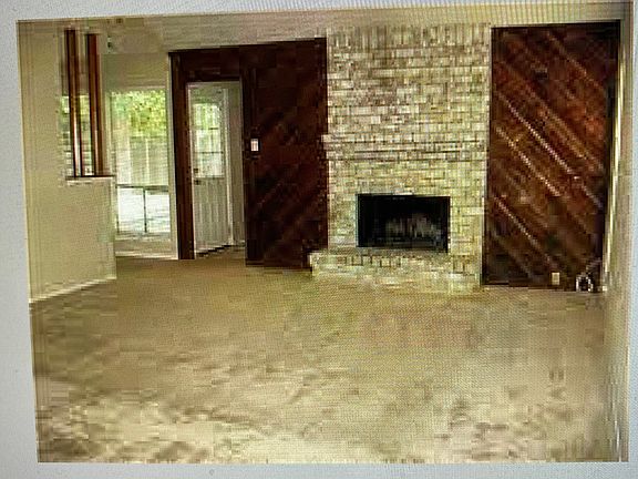 Very large living room with fireplace, back door