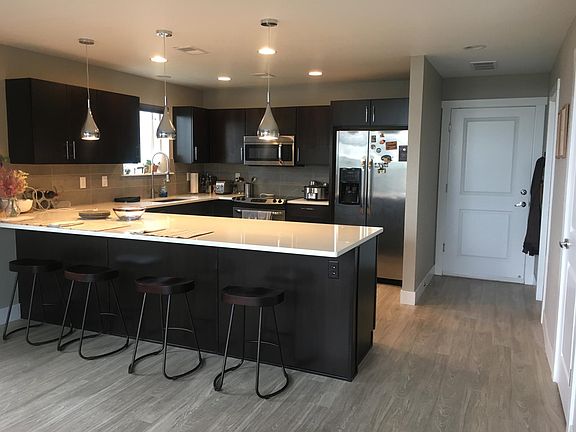 Kitchen/dining area with adjacent garage, 1/2 bathroom and closet.