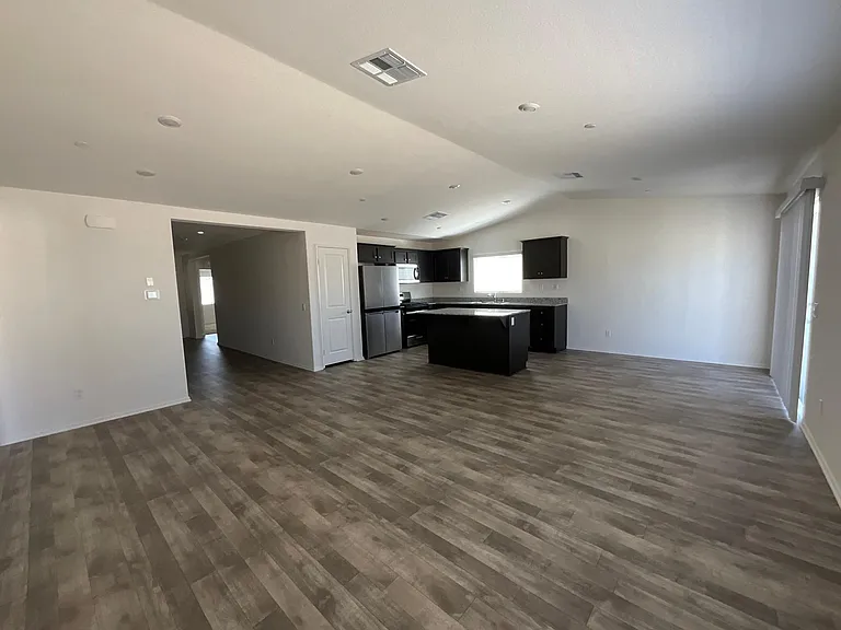 Full view of kitchen dining room and slider to back yard