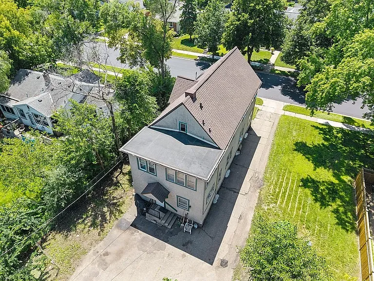 Back of home showing large driveway for off-street parking