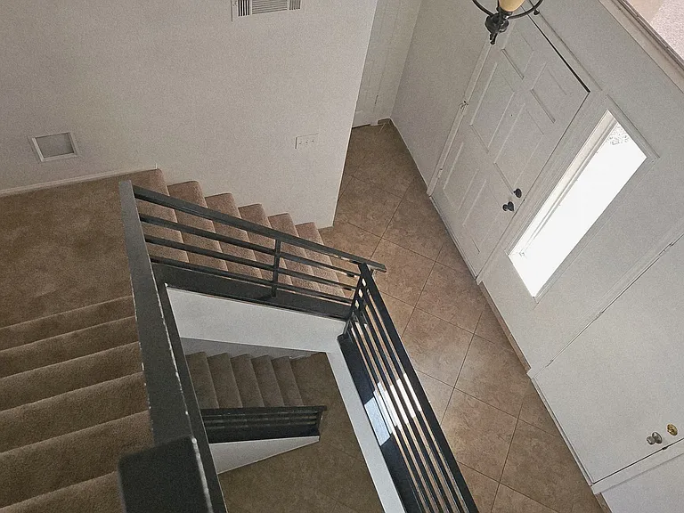 View from the upper level showcasing the open stairway and the home's unique tri-level layout with seamless flow between levels.