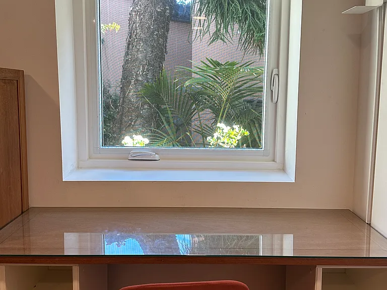 Writer's desk with serene view from window that opens to the sounds of the sea. Four spot/night lights with USB charger shelves: at desk, reading nook, and bedsides.