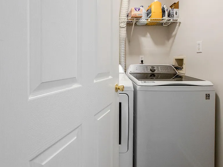SEPARATE LAUNDRY ROOM WITH NEW WASHER AND DRYER