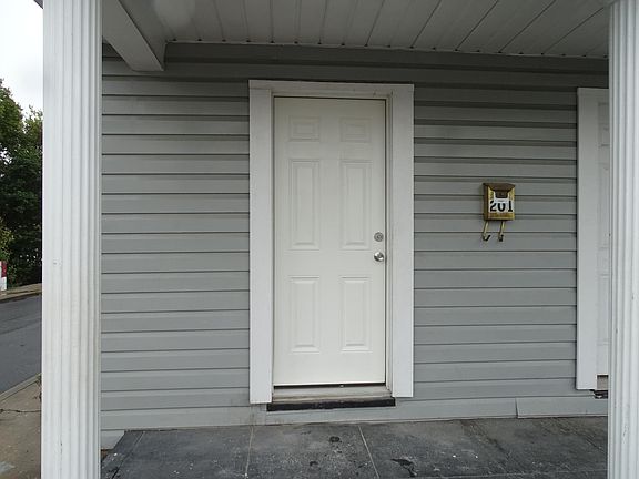 Front entry into living room with kitchen entry on opposite side.