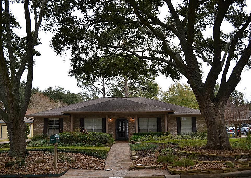 Gorgeous one story home with immaculate landscaping and mature trees.
