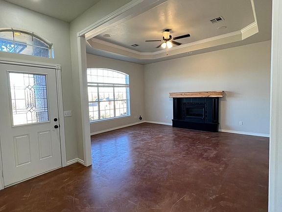 Open living with tall ceilings and stained concrete