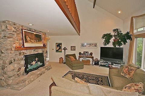 Living area with grand fire place and vaulted ceiling