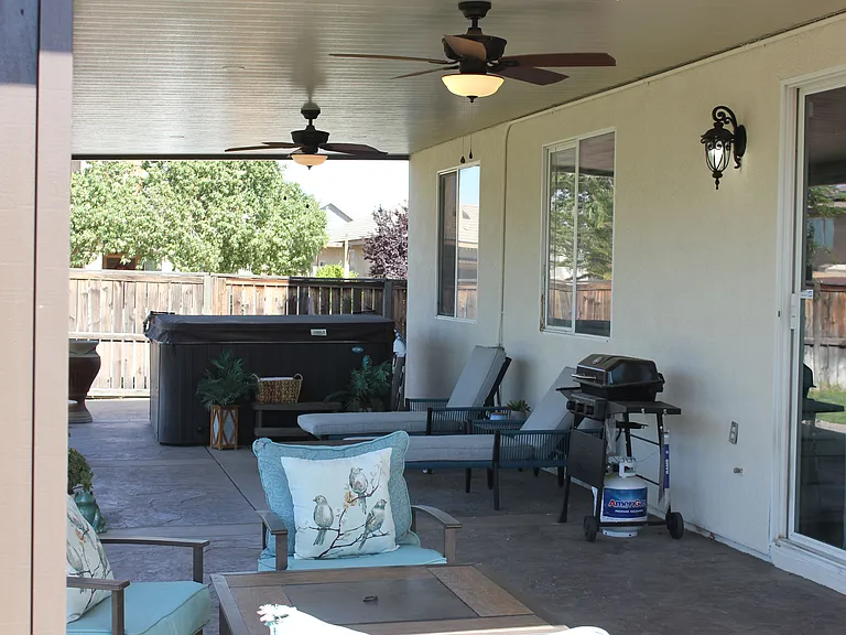 Covered outdoor patio with recessed lighting and ceiling fans