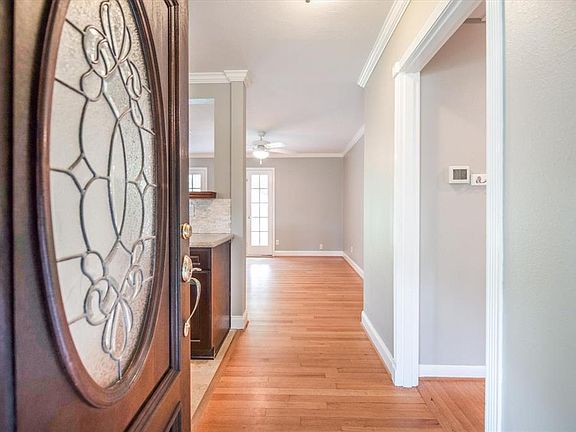 Inviting leaded glass front door. Light & bright with gorgeous REAL hardwood floors!