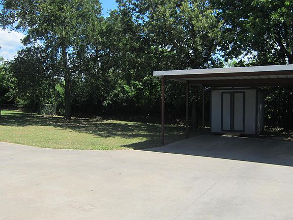 2 car carport and outside storage shed in backyard