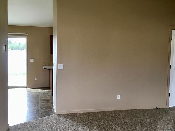 Living room looking towards dining room leading to kitchen and family room areas.