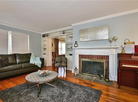 Living room with wood burning fireplace.