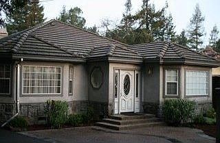 Tudor with stucco exterior and cement tile roof