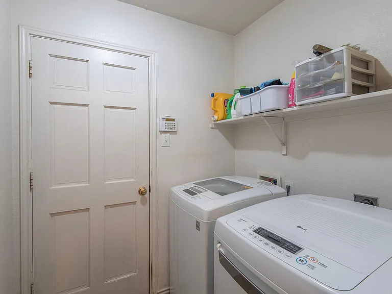 Utility room. Comes w/ washer, dryer, and fridge included in the rent