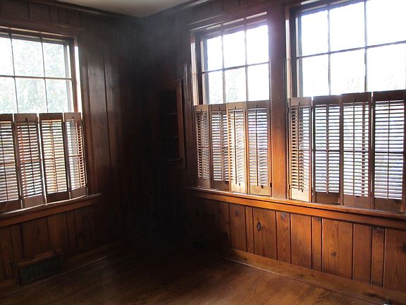 8x11 study with wood shutters. Has a closet with shelves. Pretty room.