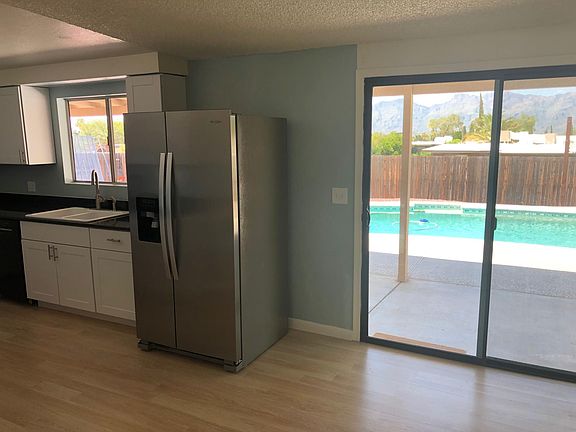 Kitchen and partial view of the eat-in area leading out to the pool