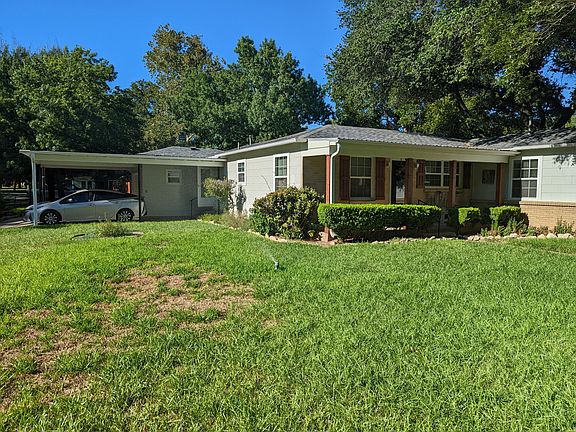 Side yard with covered parking.