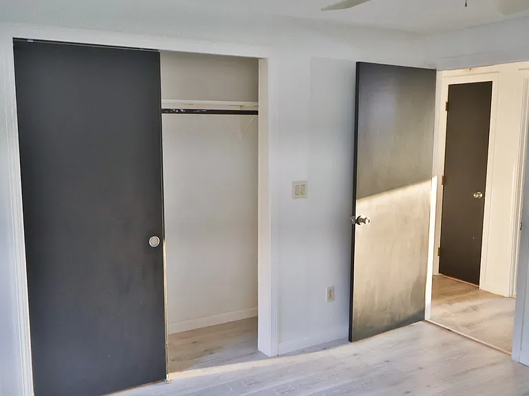 Bedroom 1 _ Fully Renovated with Freshly Painted Walls and Doors, Plus Brand-New Flooring Throughout.