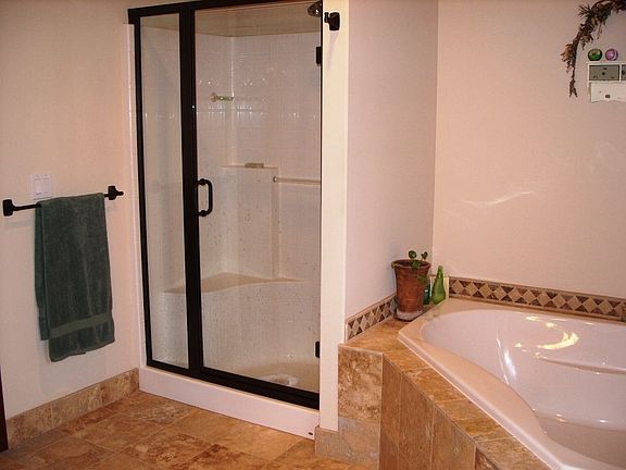 Master bath with large spa tub, travertine floors and double sinks