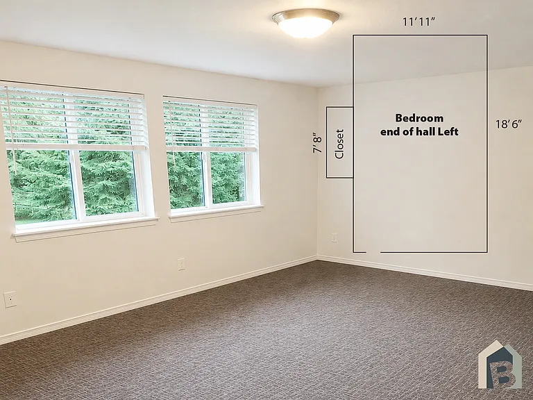 2nd floor large bedroom with view of lawn and mature evergreen trees and double closet