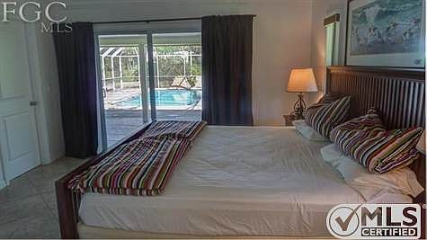 master bed room with exit to the back lanai and heated pool