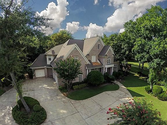 Spacious, custom home in the well sought after gated neighborhood of Cinco Ranch Bayou Park Estates on a lush corner lot without neighbors in the back.