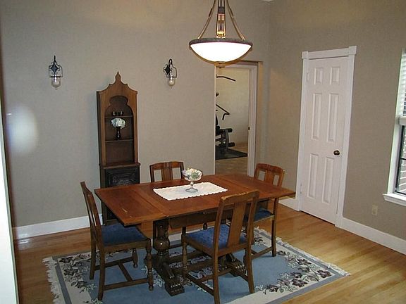An open concept plan makes the formal dining room be flexible in use. Reclaimed wood floors in entry
