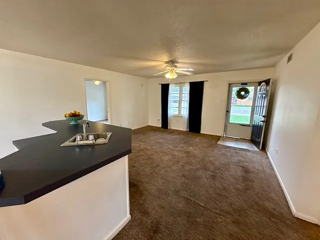 View of living room and kitchen.