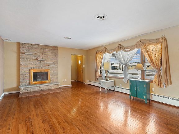 Re-finished original hardwood floors, a wall of windows and a wood-burning fireplace warm up this wo